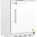 A white laboratory freezer, similar to Undercounter Refrigerators, features a front door handle, digital temperature display at -14.0°C, and a lock. The ABS American BioTech Supply logo is on the upper left, with a small green leaf icon on the lower right corner.