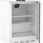 A white undercounter refrigerator with a glass door is open, revealing three empty wire shelves inside. The control panel above displays a digital temperature of 4.9°C. A ventilation fan is mounted on the inner back wall. The unit is clean and well-lit.