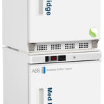 A white medical fridge stacked on top of a white medical freezer, both labeled with blue text. Each unit has a handle on the left and digital temperature displays. Both appliances have the American BioTech Supply logo and a green circular emblem.