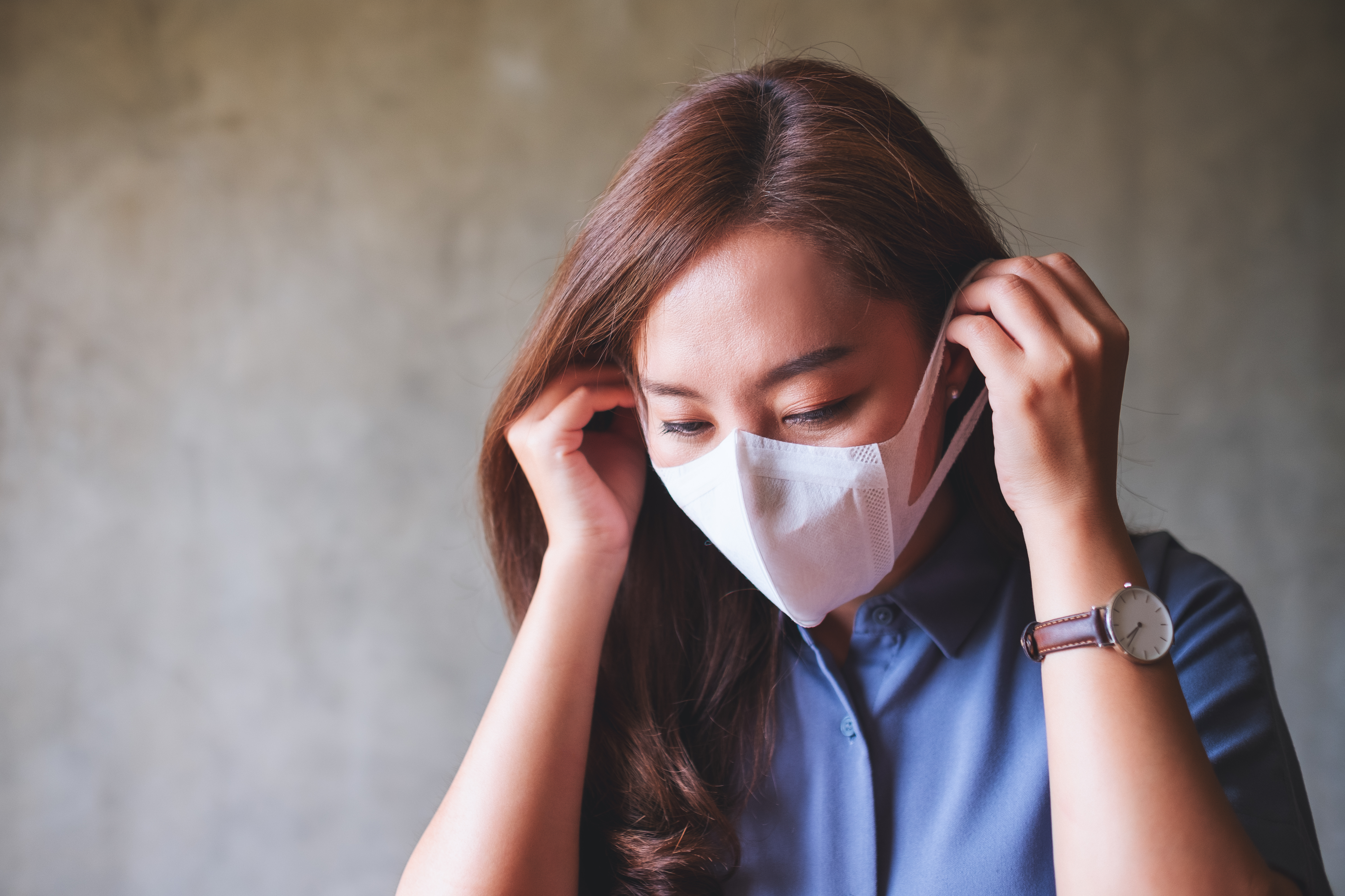 asain woman putting mask for covid 19
