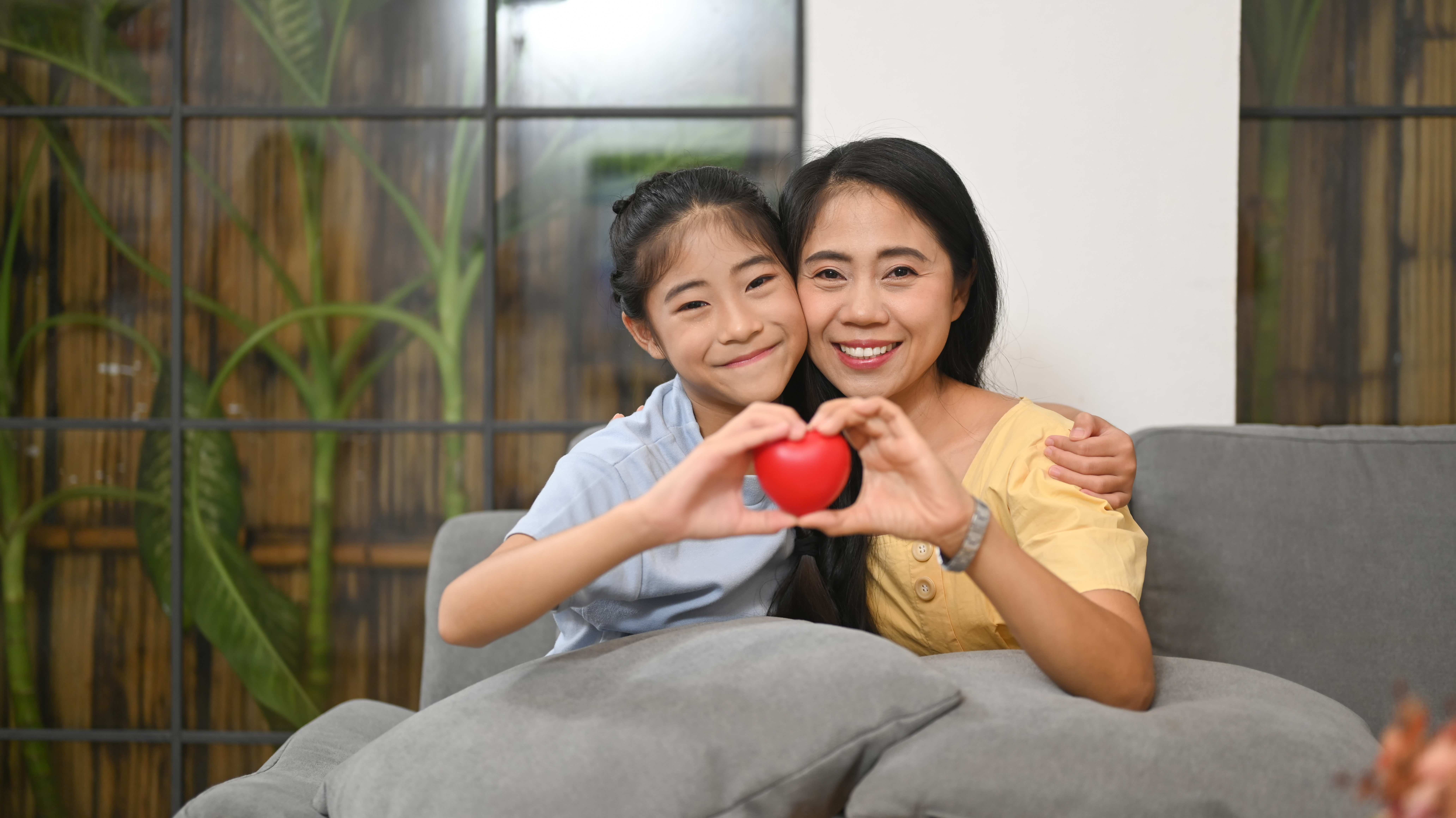 girl and mother holding heart