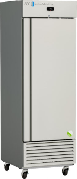 A tall, upright, silver and white laboratory freezer on wheels. The door has the American BioTech Supply logo and a small digital display at the top. The base features vent slats, and a green circular sticker appears on the lower right of the door.
