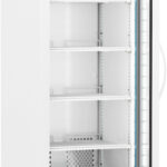 A tall, white laboratory refrigerator with a glass door stands open, revealing five empty wire shelves. A digital display on top shows a temperature of 4.0°C. The unit has wheels and a vent at the bottom, with interior lighting and a visible thermometer inside.