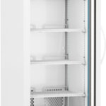 A tall, white laboratory refrigerator with a glass door is open, showing five empty wire shelves inside. The control panel on top displays temperature settings. The unit has vents at the bottom and sits on four caster wheels for mobility.