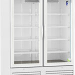 A large, white medical refrigerator with two glass doors, five adjustable shelves per side, a digital control panel on top, and ventilation slots at the bottom; the interior is brightly lit and empty. The unit is on wheels for mobility.