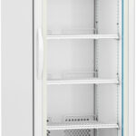 A tall, white, commercial refrigerator with a glass door, four adjustable wire shelves, ventilation grilles at the bottom, and wheels for mobility. The display shows the temperature. The ABS logo is on the upper left corner of the front panel.