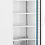 A tall, white laboratory refrigerator with a glass door stands open, revealing five adjustable wire shelves inside. The control panel is at the top, and the unit sits on four caster wheels for mobility. The interior is well-lit with vertical LED lights.