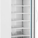 A tall, white laboratory refrigerator with a transparent glass door, digital temperature display, six wire shelves, ventilation slots, and caster wheels. The fridge is empty and the door is slightly open, showing the clean interior and shelving.