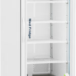 A tall, white, upright medical refrigerator with a glass door, digital temperature display at the top, and five adjustable interior shelves. The unit is on wheels, has “Med Fridge” text on the door, and features internal LED lighting and air vents at the bottom.