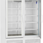 A tall, white laboratory refrigerator with two glass sliding doors, several adjustable wire shelves inside, a digital temperature display above the doors, and ventilation panels at the base. The interior is empty and well-lit.