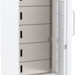 A tall, white commercial refrigerator with an open door, revealing four stainless steel shelves and a vented panel at the bottom. The fridge stands on four caster wheels and has a vertical handle on the right side of the door.