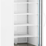 A tall, white laboratory refrigerator with a glass door is open, revealing five empty wire shelves inside. A digital display at the top shows a temperature of 4.0°C. The refrigerator has wheels and a vent near the bottom.