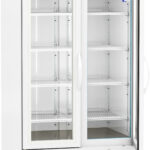 A white, upright, double-door laboratory refrigerator by American BioTech Supply, with glass doors, multiple adjustable wire shelves, a digital temperature display, and ventilation grilles at the bottom, standing on caster wheels. The interior is empty.
