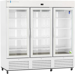 A large, white, three-door commercial refrigerator with glass doors showing empty adjustable shelves inside, vents at the bottom, wheels for mobility, and a digital display at the top center. The doors have vertical handles and the interior is brightly lit.