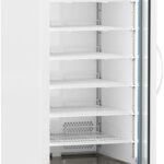 A tall, white medical refrigerator with a glass door is open, revealing seven empty wire shelves inside. The top panel displays a digital temperature reading. The unit is on wheels, has a large handle, and a grated vent at the bottom.