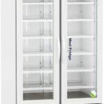 A tall, white medical refrigerator with glass double doors and shelves inside. The display panel shows a digital temperature. The label reads “Med Fridge.” The unit stands on wheels and has ventilation grilles at the bottom. Manufactured by American BioTech Supply.