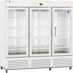 A large, white, three-door medical refrigerator with glass doors and multiple empty wire shelves. The interior is brightly lit, and the unit is on wheels. The control panel is at the top, and vents are at the bottom. Med Fridge is labeled on the right door.