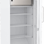A tall, white, upright freezer with its door open, revealing three adjustable wire shelves, a bottom compartment, and a large metallic cooling unit at the top. The interior is empty and clean, with a handle on the door’s right side.