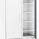 A tall, white, double-door laboratory refrigerator by American BioTech Supply. The right door is glass, showing five empty wire shelves inside. The left door is solid. A digital temperature display is above the doors. The unit has ventilation grilles and wheels.