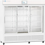A large, white, commercial display refrigerator with three sliding glass doors, empty wire shelves inside, and a digital temperature display reading 4.0°C at the top center. Vents are located along the bottom front panel.