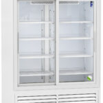 A tall, white commercial refrigerator with glass sliding doors, multiple adjustable wire shelves, digital temperature display, ventilation grilles at the bottom, and wheels for mobility. The interior is brightly lit and empty. Branding reads American BioTech Supply.