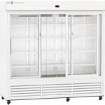 A large, commercial, glass-door refrigerator with three sliding doors and multiple adjustable wire shelves inside. The fridge is white, has a vented bottom panel, and is empty, with a digital display at the top center.
