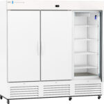 A large, white commercial refrigerator with two closed doors on the left and one open door on the right, revealing multiple adjustable wire shelves inside. The unit has ventilation grilles at the bottom and sits on wheels.