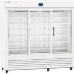 Large white commercial refrigerator with three sliding glass doors, empty wire shelves inside, a digital temperature display above the center door, and vents at the bottom. The label Med Fridge appears on the right door. The unit is on wheels.