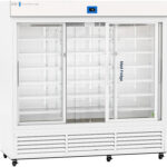 A large, white commercial refrigerator with three clear sliding glass doors and multiple empty wire shelves inside. An electronic temperature display is on top, and Med Fridge is labeled on the central door. The bottom section has ventilation grilles.