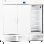 A large, white, commercial refrigerator with three sections; the rightmost door is open, revealing multiple empty shelves inside. A digital temperature display is centered above the doors. The unit stands on caster wheels.