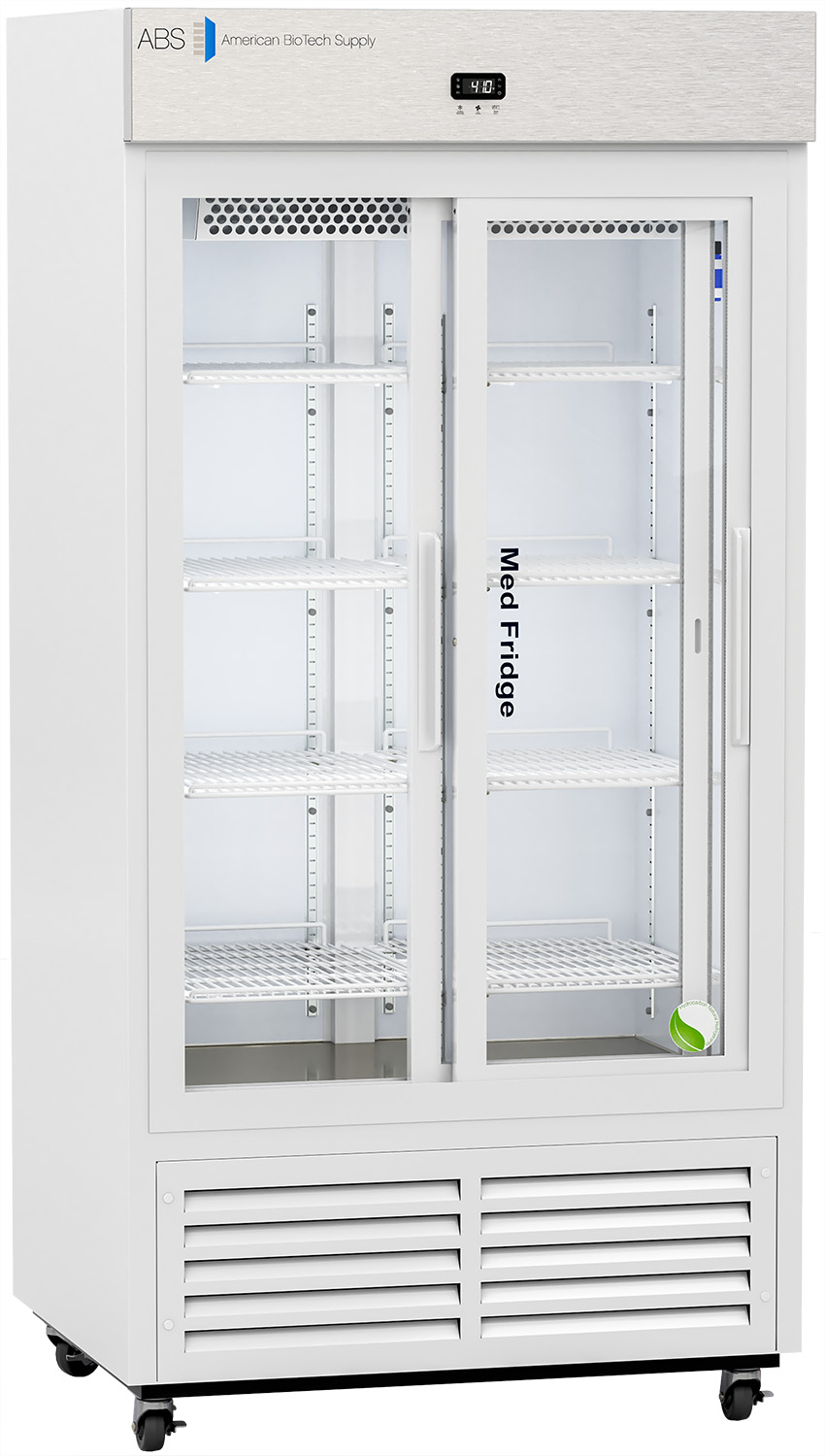A tall, white medical refrigerator with glass double doors showing empty wire shelves inside. The control panel is above the doors, and the bottom has a vent. The label reads Med Fridge and American Biotech Supply. The fridge is on caster wheels.