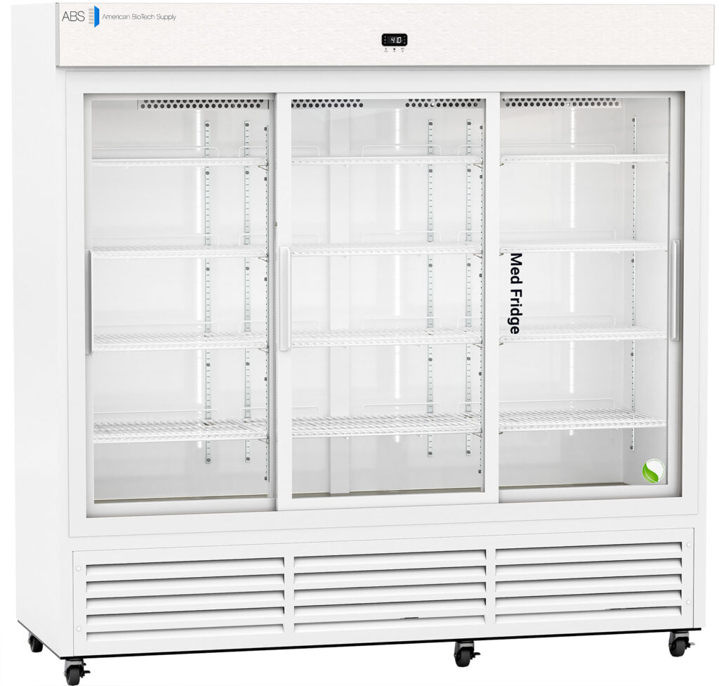 A large, white commercial refrigerator with three sliding glass doors, empty shelves inside, a digital temperature display on top, and a small green and white item in the lower right corner. The words Med Fridge appear on the middle door.