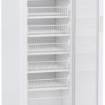 A tall, white medical refrigerator with a transparent door is open, revealing seven metal wire shelves inside. The top right displays a digital temperature panel. The fridge stands on short legs against a white background.