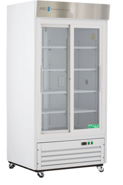A tall, white, commercial refrigerator with glass double doors, metal shelves inside, and a stainless steel top panel labeled “American Biotech Supply.” The unit has vents at the bottom, control buttons, and is mounted on caster wheels.