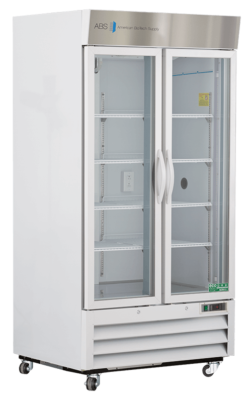 A large, white laboratory refrigerator with double glass doors, silver handles, and a stainless steel top labeled American BioTech Supply. The unit has multiple empty shelves inside and sits on four caster wheels for mobility.