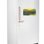 A white upright freezer labeled ABS American Biotech Supply with a vertical handle on the left. The door displays large yellow warning labels for flammable material and fire safety, and a smaller red caution label near the handle.