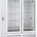 A large, upright, white laboratory refrigerator with two glass doors, metal handles, and multiple adjustable wire shelves inside. A digital temperature display is on the top panel; the bottom front features ventilation grilles. The interior appears empty.