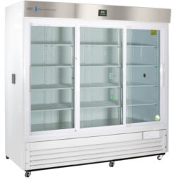 A large, commercial white refrigerator with three clear glass sliding doors, empty interior shelves, a digital display above, and a stainless steel upper panel. The unit stands on small wheels and has ventilation grilles at the bottom.