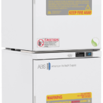 Two stacked, white laboratory refrigerators labeled American BioTech Supply. Each unit displays warning labels about hazardous contents and fire risk, with digital temperature displays and caution signs, emphasizing safety and specialized use.