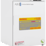 A white American BioTech Supply Hazardous Location Undercounter Refrigerator features a digital display, large yellow and red hazardous location warning label reading “KEEP FIRE AWAY,” and an additional caution label on the lower left front door.