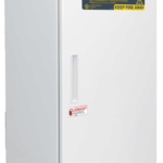 A tall, white laboratory refrigerator by American BioTech Supply stands upright. The door has warning labels, including a yellow sign reading “Flammable Material Storage” and “Keep Fire Away.” A handle is centered vertically on the door’s left edge.
