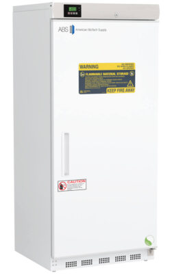 A tall, white laboratory refrigerator with a digital display on top, labeled “ABS American BioTech Supply.” The door has yellow and red warning labels stating, “Flammable Material Storage” and “Keep Fire Away,” as well as a caution notice near the handle.