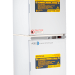 Two stacked laboratory refrigerators from American BioTech Supply with digital temperature displays. Each door displays yellow “flammable material storage” warning labels and smaller red caution labels at the bottom, indicating restricted storage and fire safety.