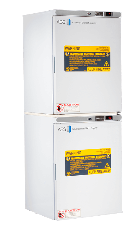 Two stacked laboratory refrigerators from American BioTech Supply with digital temperature displays. Each door displays yellow “flammable material storage” warning labels and smaller red caution labels at the bottom, indicating restricted storage and fire safety.