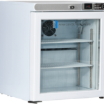 A small, white laboratory refrigerator with a glass front door, digital control panel, visible temperature display, two adjustable shelves, and an interior fan. The logo “American BioTech Supply” is printed on the inside wall.