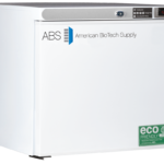 A white chest freezer labeled “ABS American BioTech Supply” displays an electronic control panel reading –20°C. The front features eco-friendly and HFC-free labels. The lid is black, and the overall design is clean and modern.