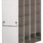 A metal shelving unit with four rows and three columns of open cubby shelves, featuring a smooth, stainless steel surface and a handle attached to one side. The shelves are empty and the unit is photographed against a white background.