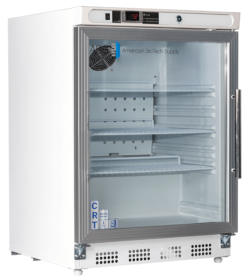 A white undercounter built in controlled room temperature medical cabinet with a glass left hinged door, metal handle, and digital temperature display. The interior has three adjustable shelves and is empty. The logo “American BioTech Supply” is visible on the upper right of the door.