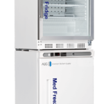 A white double-door unit with a glass-fronted top fridge labeled “Med Fridge” and a solid-door bottom freezer labeled “Med Freezer.” Both have digital displays and vents, and the unit is branded “American Biotech Supply.” Shelves are visible inside the fridge.