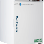 A white upright 4 cu. ft. undercounter pharmacy freezer labeled “Med Freezer” and “American BioTech Supply” on the front. The control panel and digital display are on top. A green “eco friendly” sticker is near the bottom right corner. The freezer stands on four small black feet.